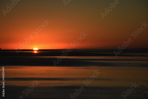 dawns behind the breakwater