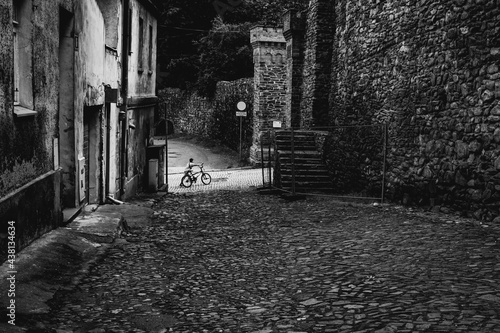 kid with bike at the street of the old town