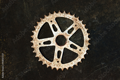 wheel with teeth from a bicycle, spinning gear sprocket on black © Sergey