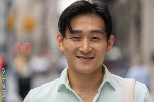 Young Asian man in city smile happy face portrait