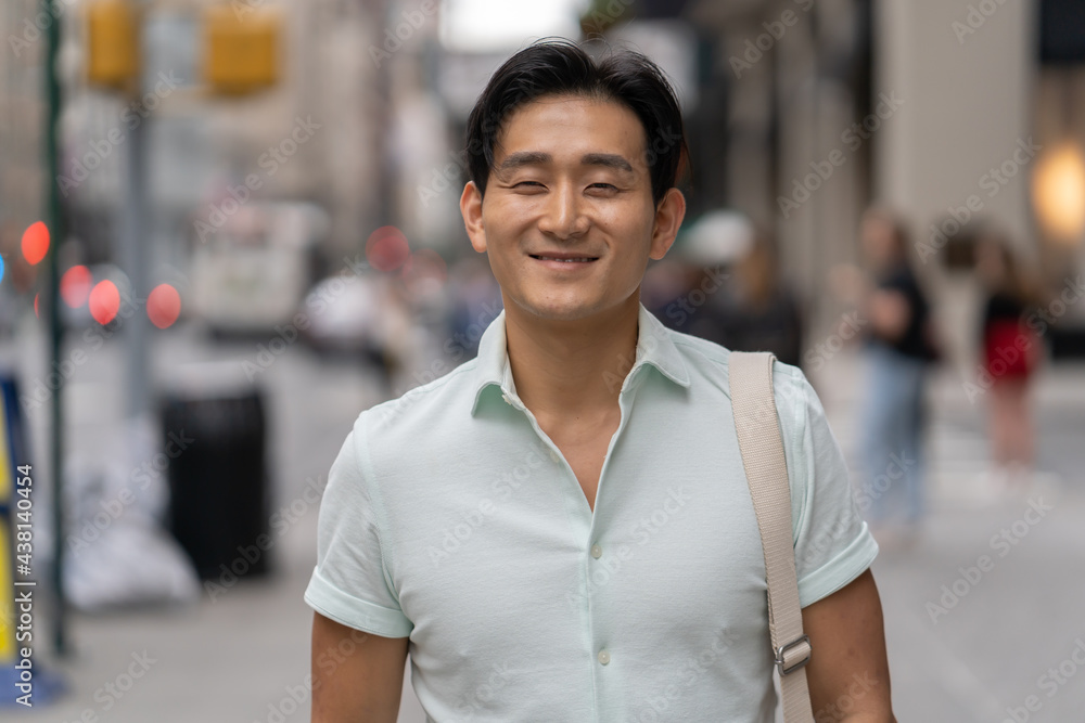 Young Asian man in city walking street smile happy face Young Asian man in city walking street smile happy face