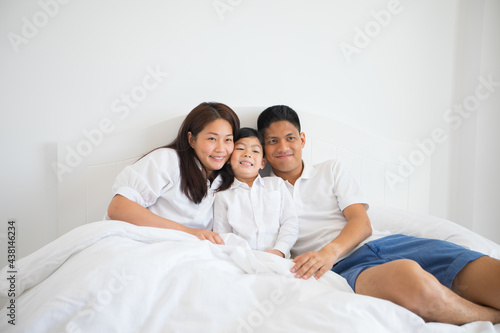  Asian family laying on bed in bedroom with happy and smile © tuiphotoengineer