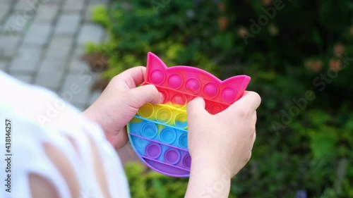 New popular silicone popit toy, baby is playing with it. Rainbow Trendy Pop it fidget toy