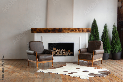 Cuadro en lienzo Spacious white country house interior in eco style with teo chairs and fireplace