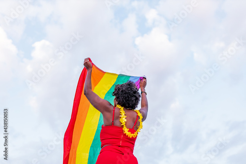 Black woman with LGBTQ flag on road photo