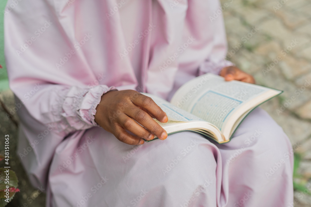 Muslim woman reading the Quran,