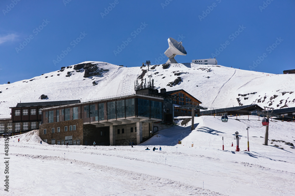 Ski resort with buildings against snowy mountain in winter Ski resort with buildings against snowy mountain in winter