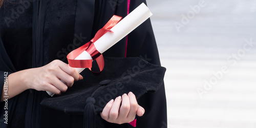 Foto Hand of college student holding diploma or education degree in commencement day,
