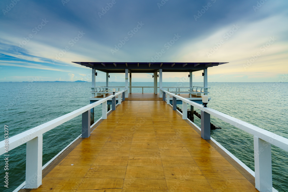 Sea or nature background with sunset and sky at twilight. Perspective view of wood bridge and pavilion. Asia travel destination in Chonburi of Thailand called Bangsaen Beach for holiday and vacation. Sea or nature background with sunset and sky at twilight. Perspective view of wood bridge and pavilion. Asia travel destination in Chonburi of Thailand called Bangsaen Beach for holiday and vacation.