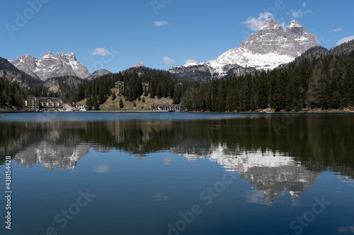 Misurina, Italy - May 31, 2021: The fabulous alpine lake in the Dolomites. Lovely and relaxing place in the Italian Alps. Reflections in the rippled water. Sunny spring day. © Maurizio