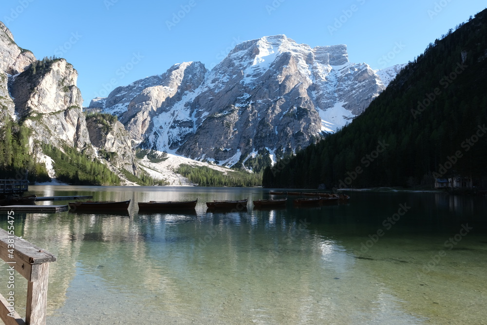 The fabulous alpine lake of Braies in the Dolomites (Bolzano). Lovely place in the Italian Alps. Boats on the water. Reflections in the water. Sunny spring day. Trentino Alto Adige