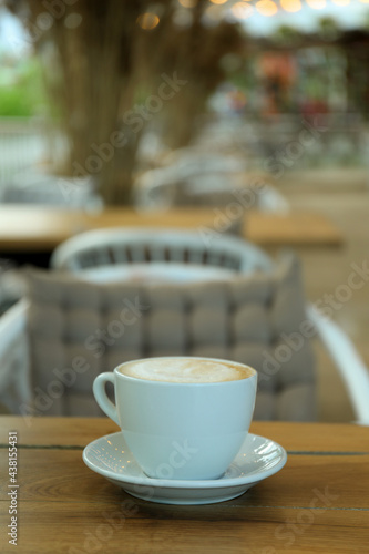 Fototapeta Naklejka Na Ścianę i Meble -  Cup of coffee on wooden table in restaurant