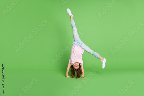 Slika na platnu Full body photo of young little girl stand on hand acrobat sporty training isola