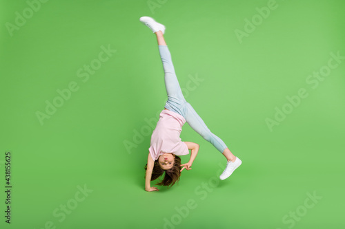 Canvas Print Full size photo of young girl handstand balance show peace cool v-sign isolated