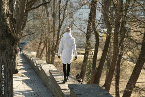 Wallpaper Mural A woman in a white jacket walks on concrete steps with a child in a park. spring in Estonia 2021. Sunny day Torontodigital.ca
