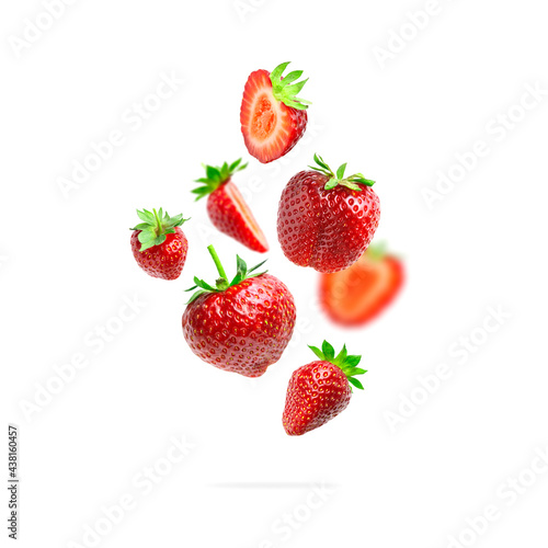 Fototapeta Naklejka Na Ścianę i Meble -  Ripe fresh flying red strawberry isolated on white background. Strawberry pattern. Summer delicious sweet berry organic fruit, food, diet, vitamins, creative layout. Whole and halved strawberries