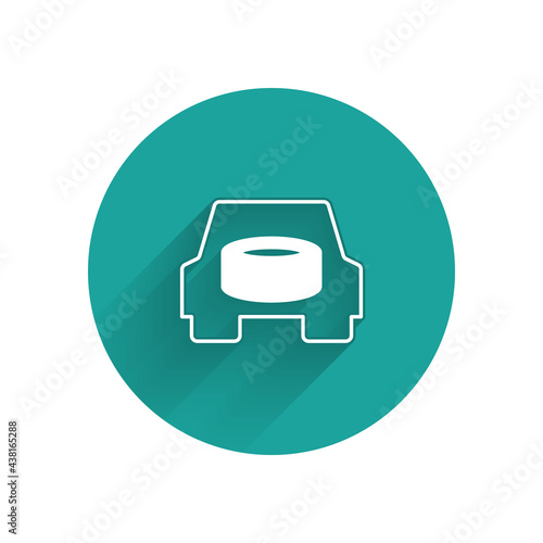 White Spare wheel in the car icon isolated with long shadow background. Process of replacing the wheel. Storage location of the spare wheel in the trunk. Green circle button. Vector