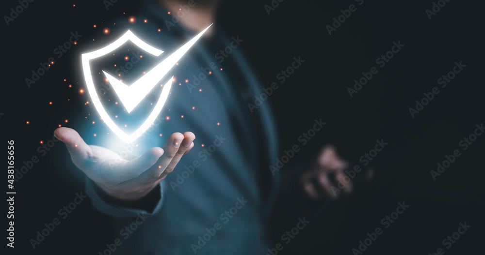 © Dilok - Businessman holding cyber security and information technology network system protection.