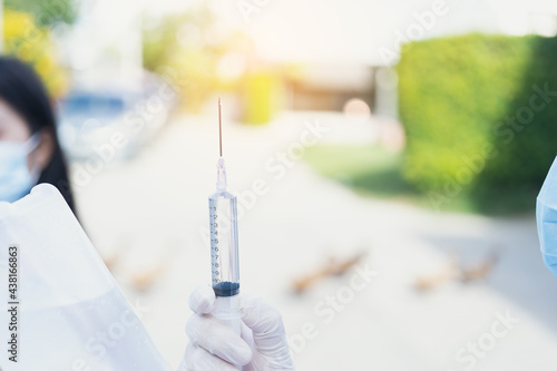 doctor holding a syringe vaccine