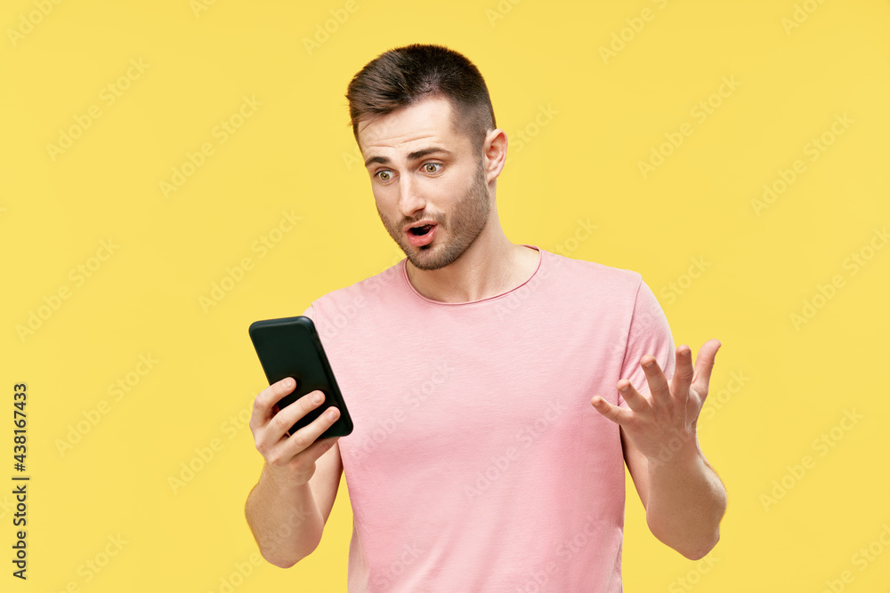 Shocked funny millennial man using mobile phone Shocked funny millennial man using mobile phone