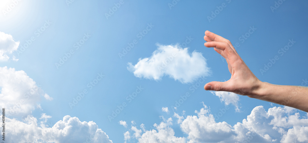 Male hand holding house icon on blue background. Property insurance and security concept.Real estate concept.Weather conditions, cloudiness.Banner with copy space Male hand holding house icon on blue background. Property insurance and security concept.Real estate concept.Weather conditions, cloudiness.Banner with copy space