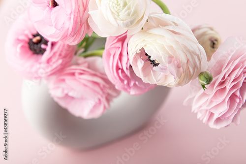 Tender ranunculus flowers in ceramic vase