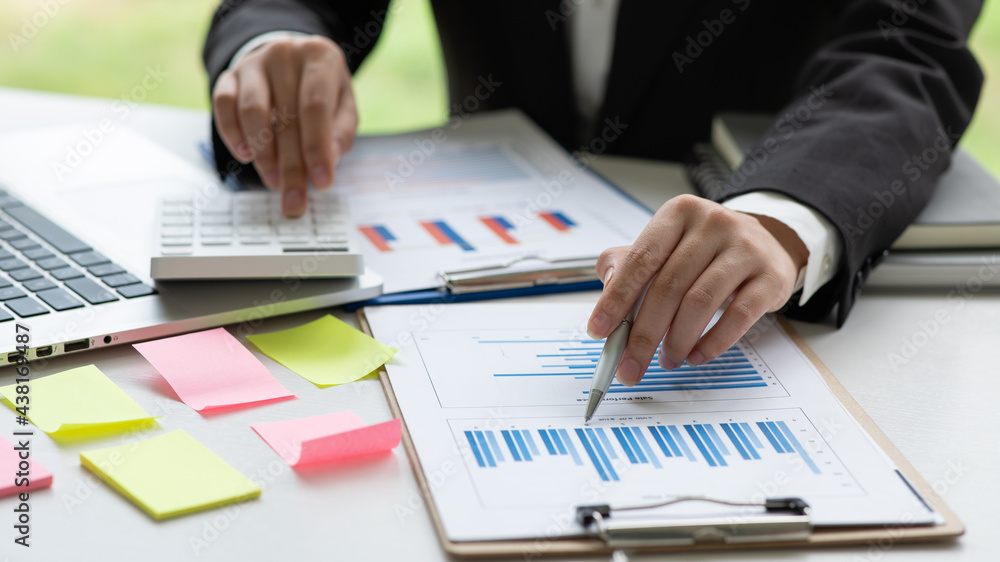 Businesswoman are calculating income-expenditure and analyzing real estate investment report and data, Accounting Financial and tax systems concept. Businesswoman are calculating income-expenditure and analyzing real estate investment report and data, Accounting Financial and tax systems concept.