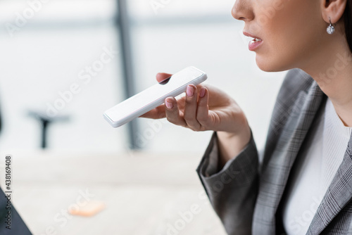 Cropped view of businesswoman with smartphone recording audio message