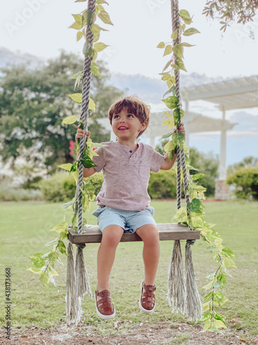 Boy playing on a swing in a park in orlando Florida at a golf course in lake nona 