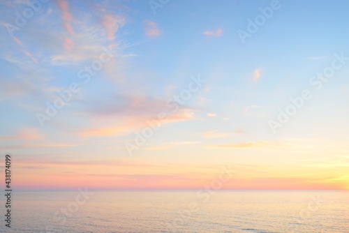 Fototapeta Naklejka Na Ścianę i Meble -  Baltic sea at sunset. Dramatic sky, blue and pink glowing clouds, soft golden sunlight, midnight sun. Picturesque dreamlike seascape, cloudscape, nature. Panoramic view