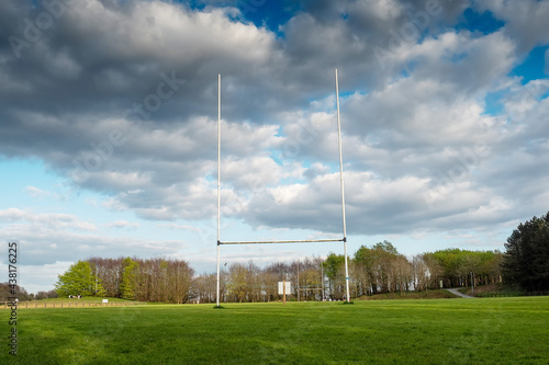 Tall goal posts for Irish national sports, camogie, hurling, Gaelic football, soccer and rugby. Warm sunny day. Blue cloudy sky.