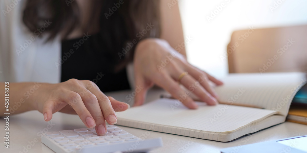 Close up Businessman using calculator and laptop for calaulating finance, tax, accounting, statistics and analytic research concept Close up Businessman using calculator and laptop for calaulating finance, tax, accounting, statistics and analytic research concept