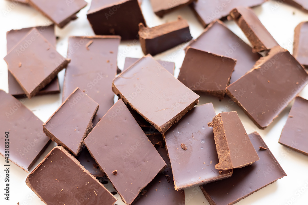 background of chocolate pieces on a white background