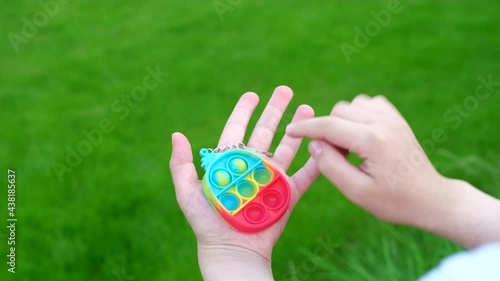 New popular silicone popit toy, baby is playing with it. Rainbow Trendy Pop it fidget toy