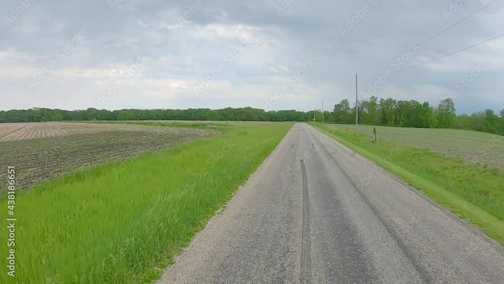 POV driving on rural country road past empty fields in eastern Illinois; Midwest USA POV driving on rural country road past empty fields in eastern Illinois; Midwest USA