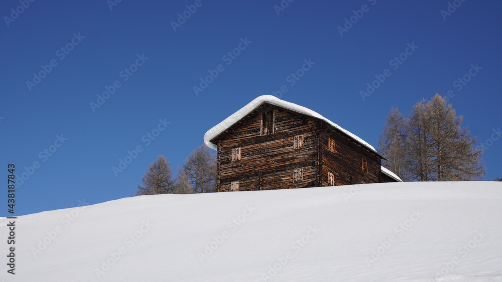 wooden house on the snow mountains 