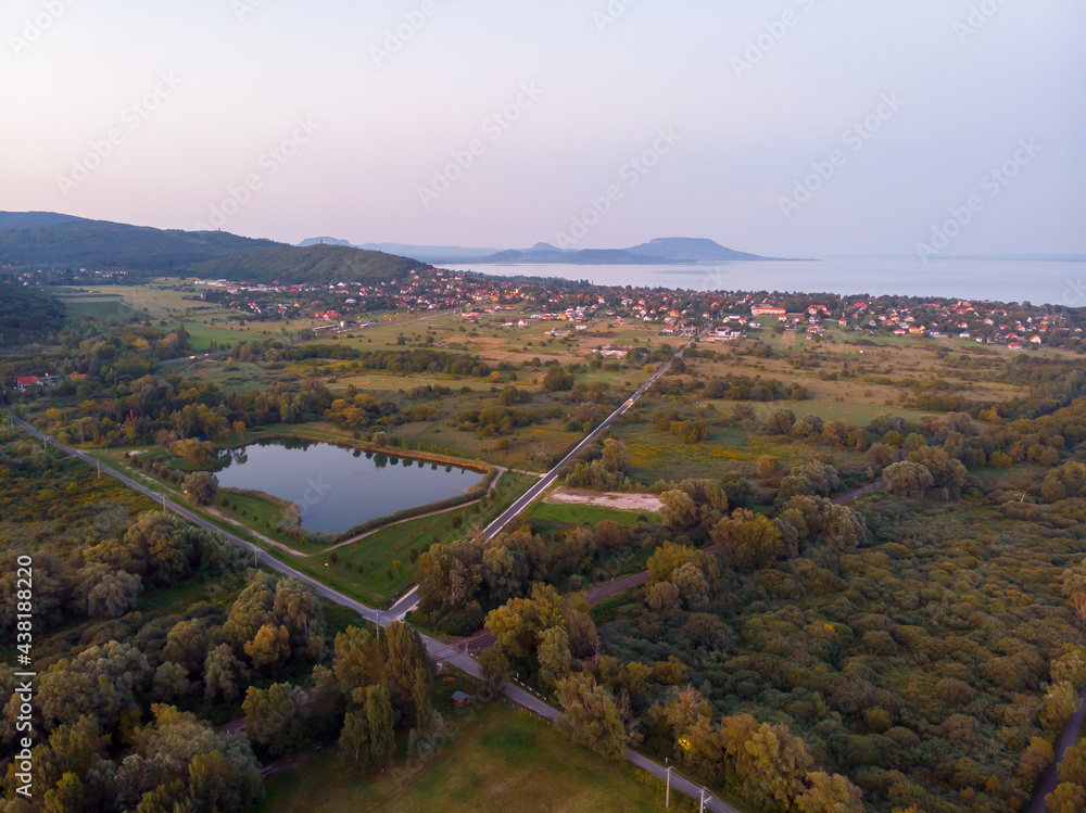 Aerial view of the hilltop chapel (St. Michael's Chapel) near Lake Balaton, at Vonyarcvashegy, background Badacsony hill at sunset Aerial view of the hilltop chapel (St. Michael's Chapel) near Lake Balaton, at Vonyarcvashegy, background Badacsony hill at sunset