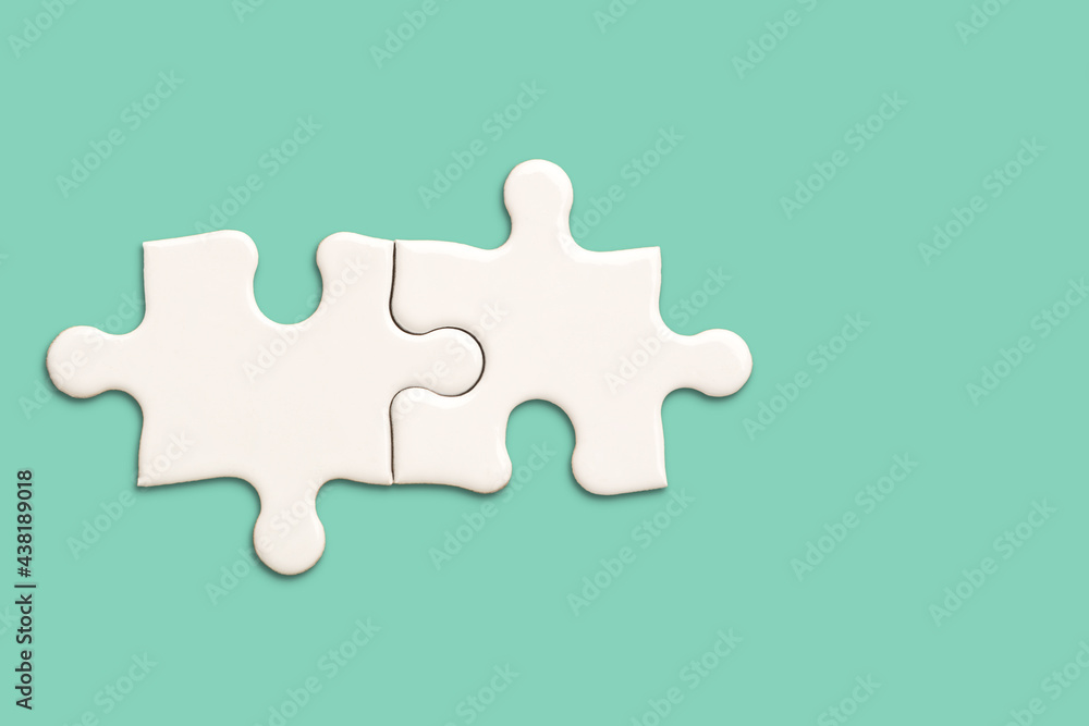 White jigsaw puzzle on green background, Find the right joined team correctly concept White jigsaw puzzle on green background, Find the right joined team correctly concept