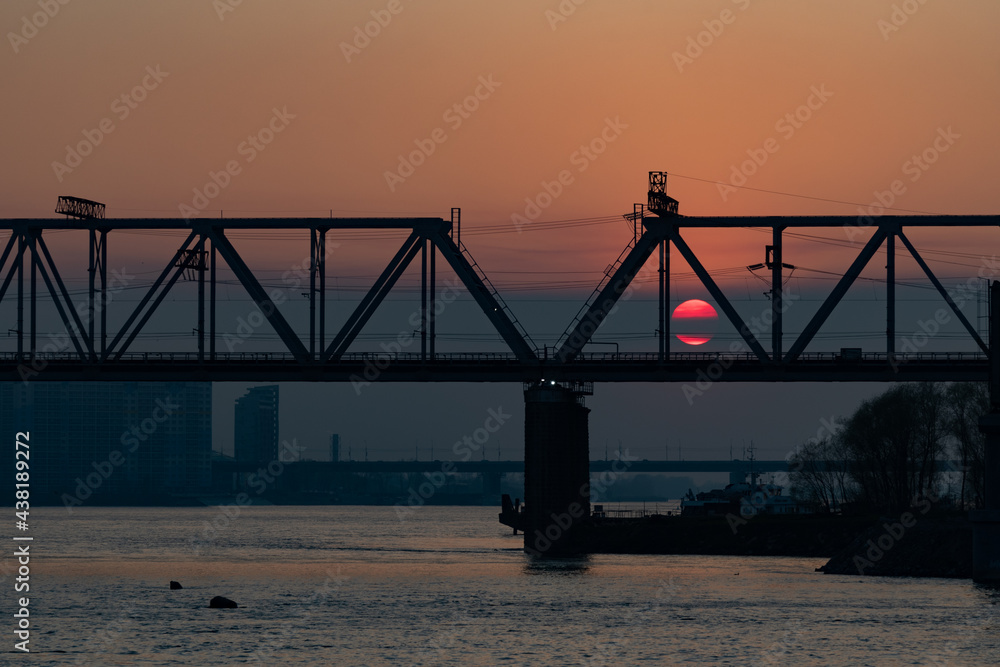 Fototapeta premium View of the Ob river at sunset. Beautiful sunset on the background of the river. 