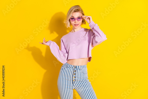 Photo of stunning happy charming young woman wear cool sunglass isolated on shine yellow color background