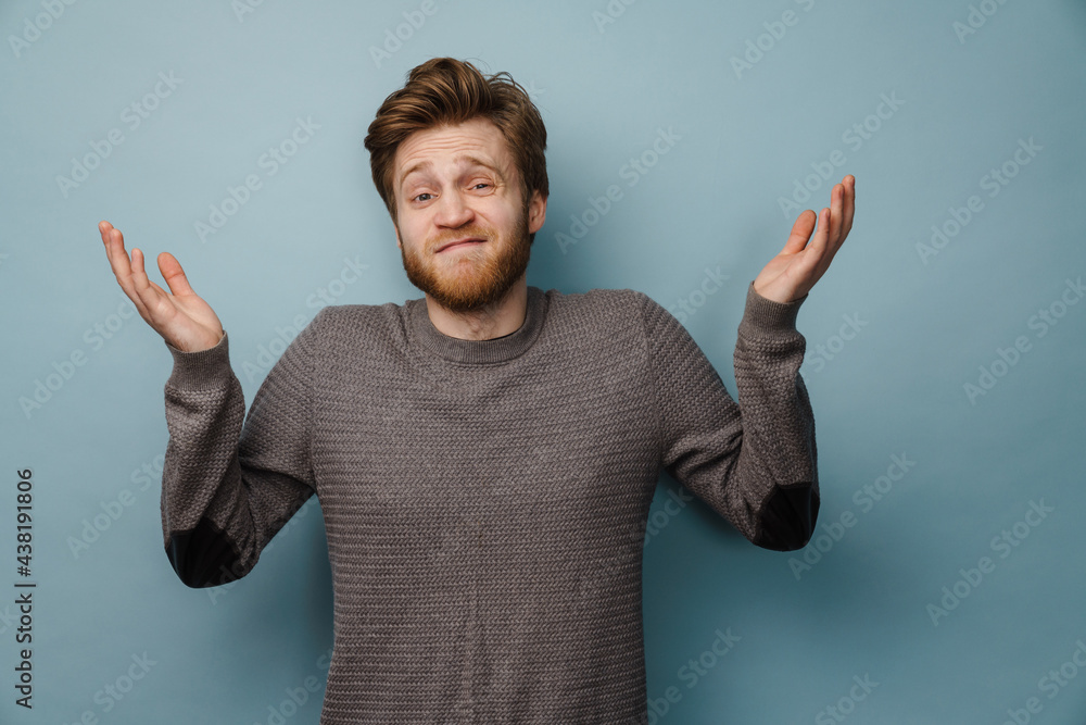 Fototapeta premium White ginger man with beard gesturing and looking at camera