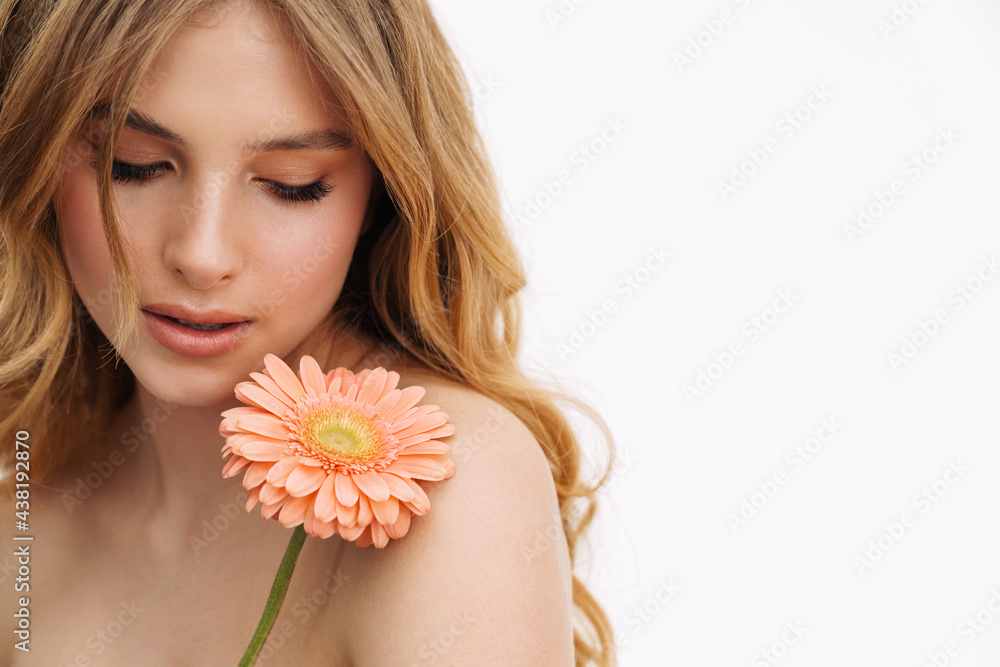 Half-naked ginger woman posing with gerbera flower