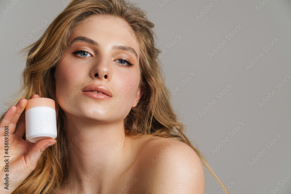 Half-naked white ginger woman posing with face cream Half-naked white ginger woman posing with face cream