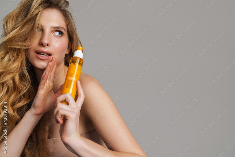 Half-naked woman showing whispering while showing beauty product Half-naked woman showing whispering while showing beauty product