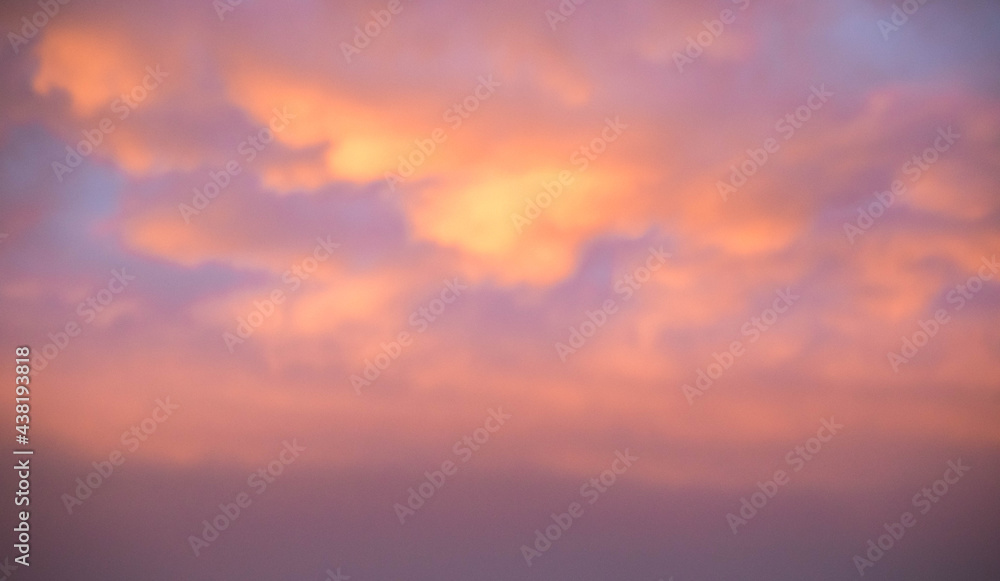 Sky with sunset. Pink and gold clouds. The lights of a sun. Dawn. Landscapes. Nature.