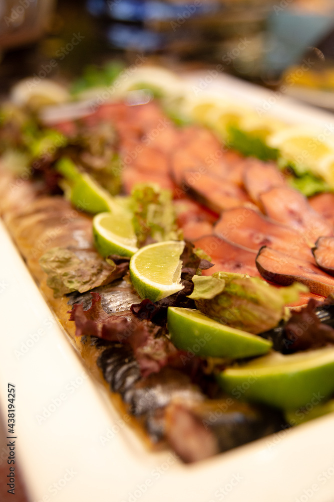 smoked fish sliced with lime slices at the buffet smoked fish sliced with lime slices at the buffet