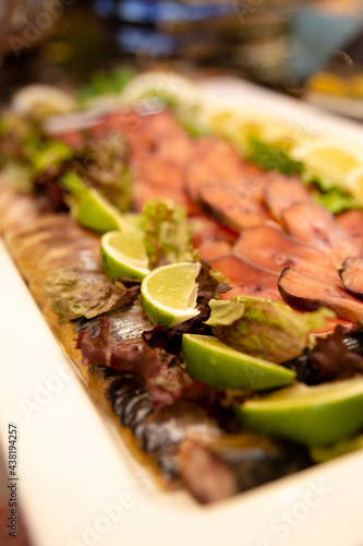 smoked fish sliced with lime slices at the buffet