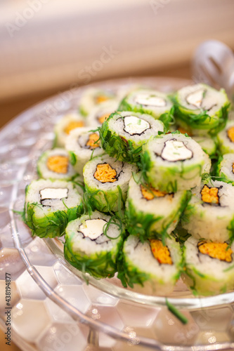 rolls with seaweed and cheese on a buffet table