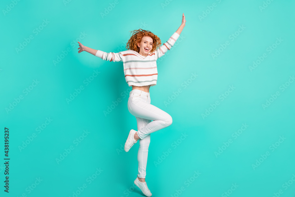 Full length body size view of lovely thin cheerful wavy-haired girl jumping having fun isolated over bright teal turquoise color background