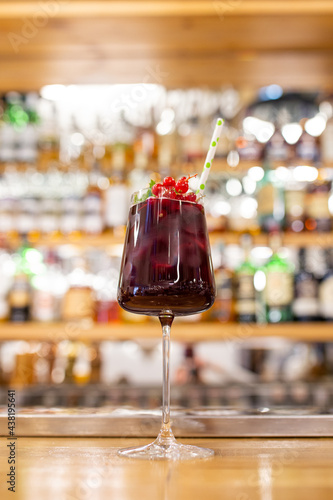 summer red cocktail with cranberries on the bar photo